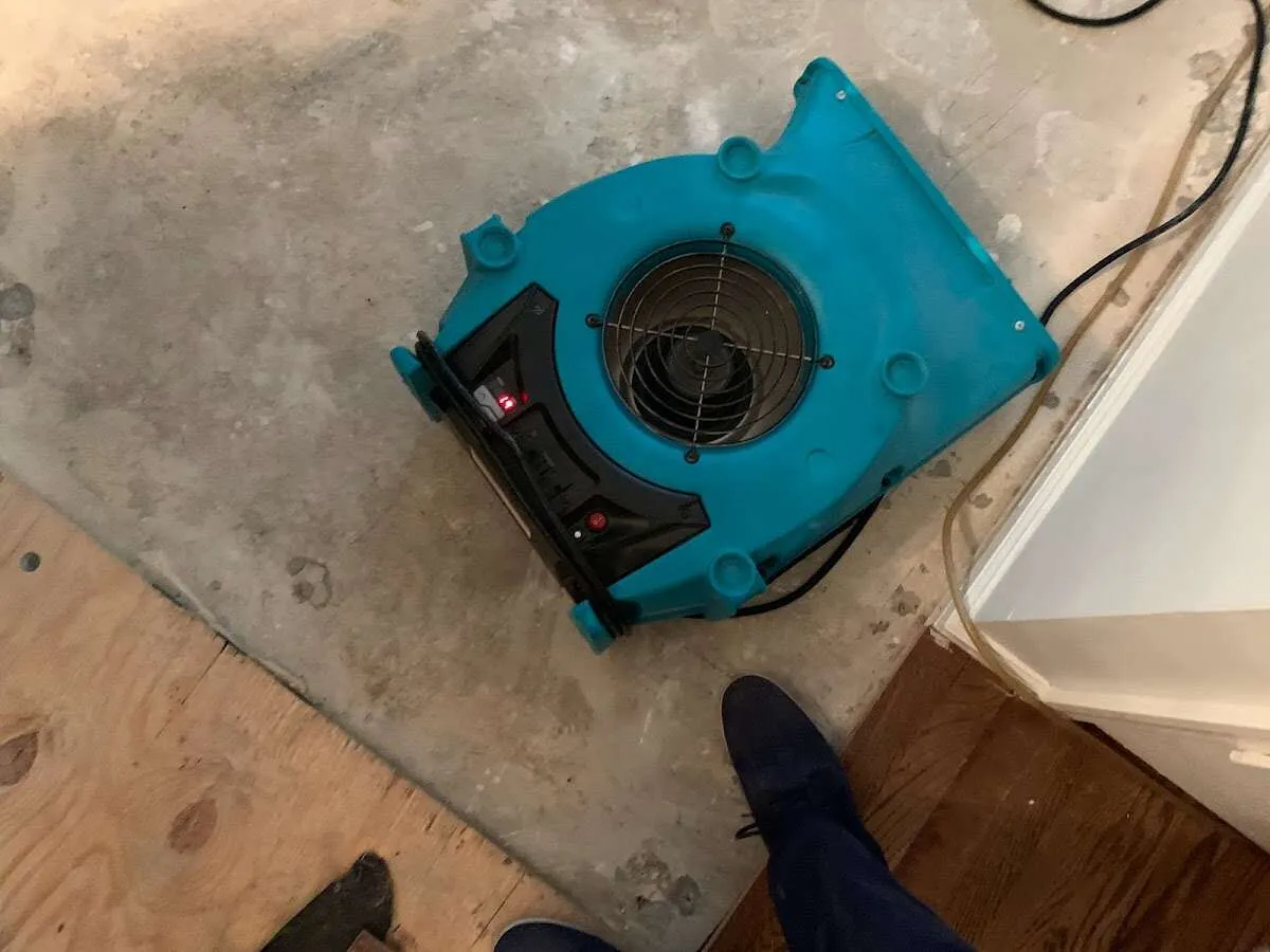 Air mover drying subfloor during Commercial Water Damage Restoration in Augusta